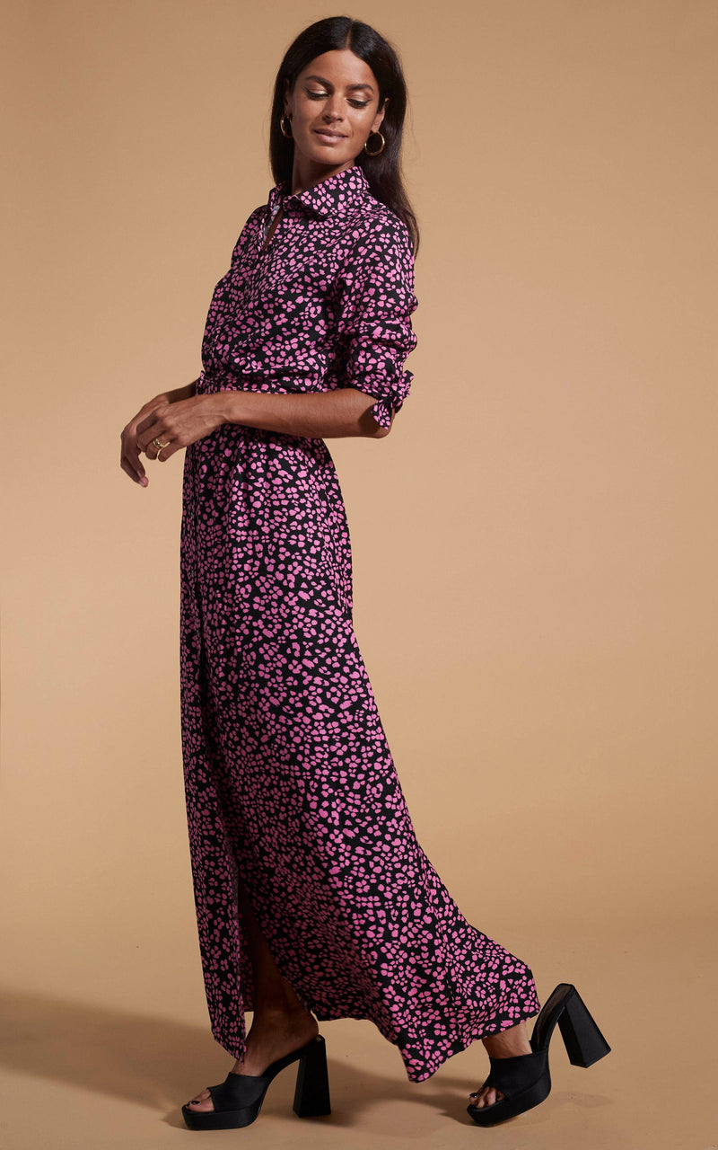 Dancing Leopard model wearing Dove Dress In Pink On Black Leopard posed looking over shoulder