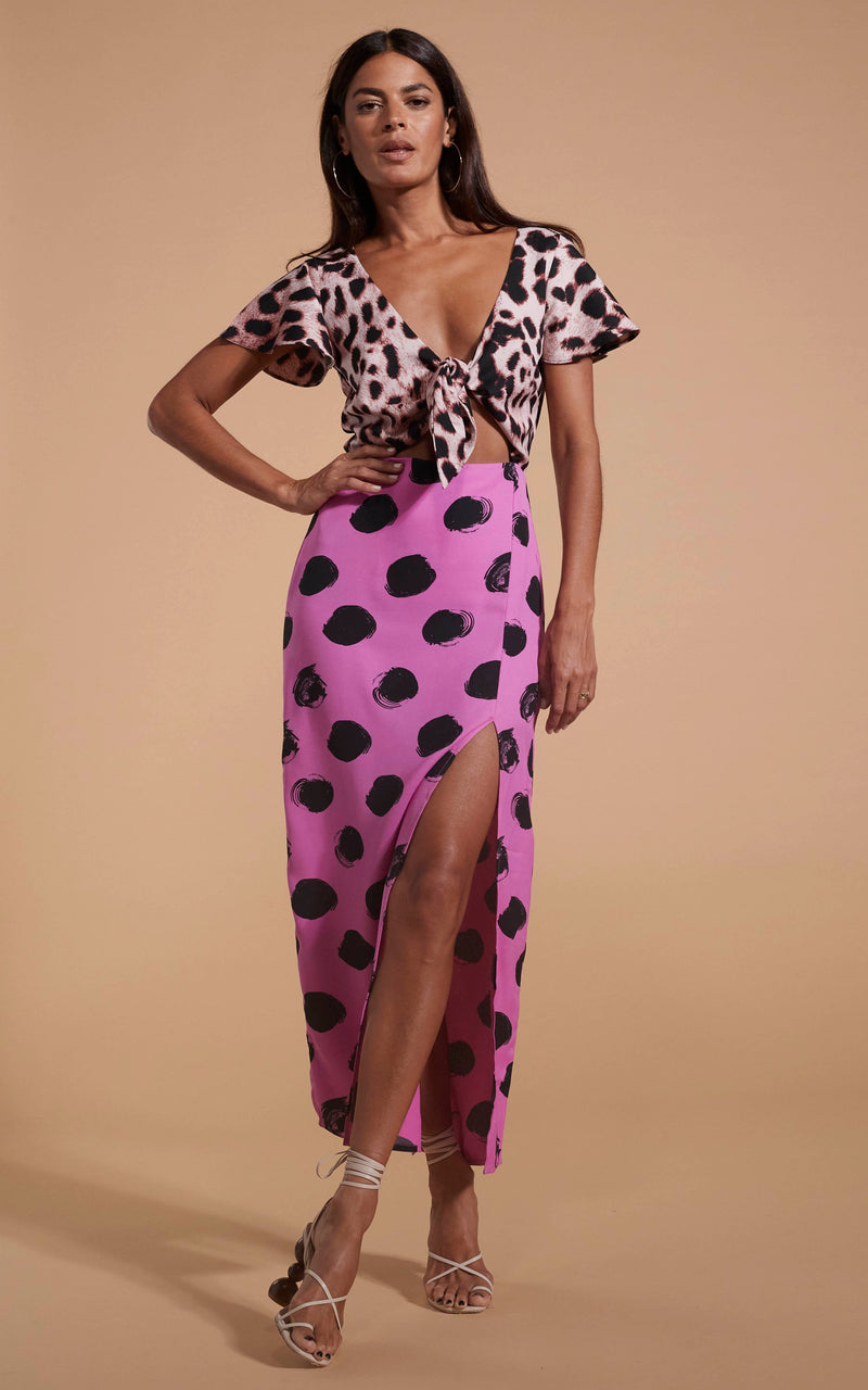 Dancing Leopard model wearing Lily Dress In Blush Leopard & Black On Pink Dot posing with hand on hip