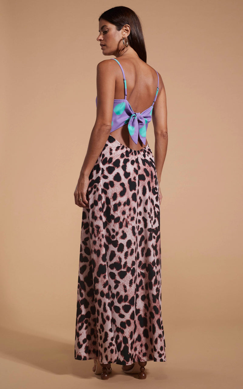 Dancing Leopard model wearing Florence Dress In Green On Purple Dot & Blush Leopard facing away to reveal back details