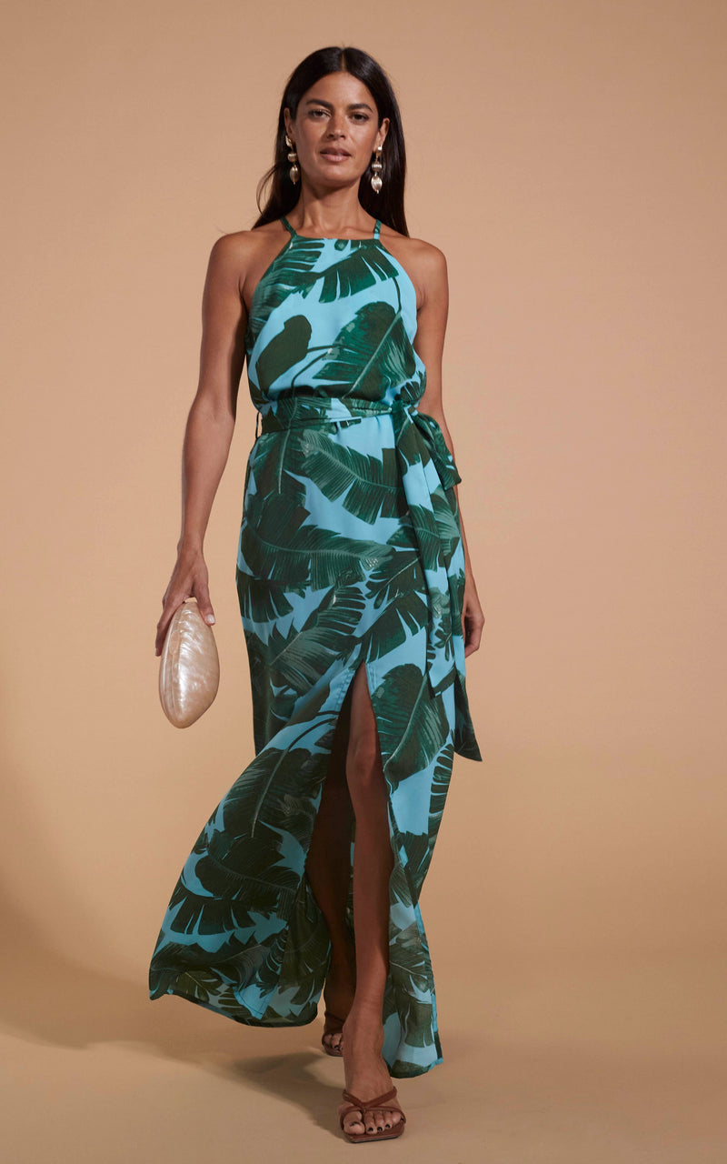 Dancing Leopard model wearing Sunset Dress In Vintage Blue Palm walking towards shot