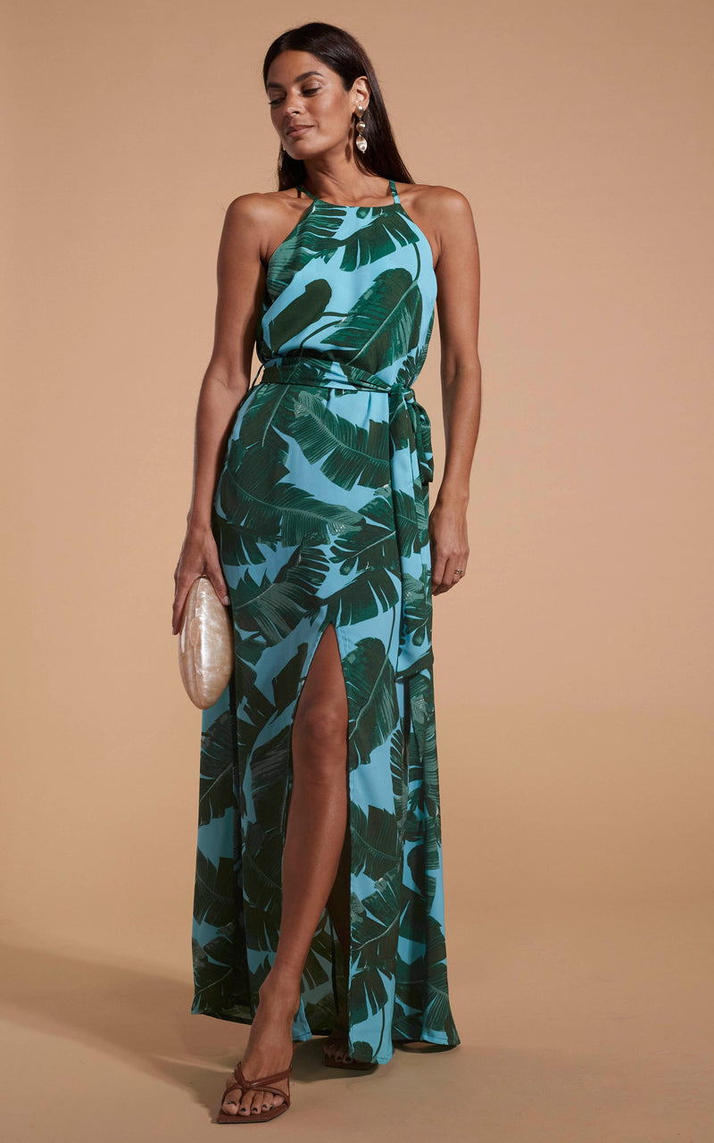 Dancing Leopard model wearing Sunset Dress In Vintage Blue Palm posed with clutch  by side looking down