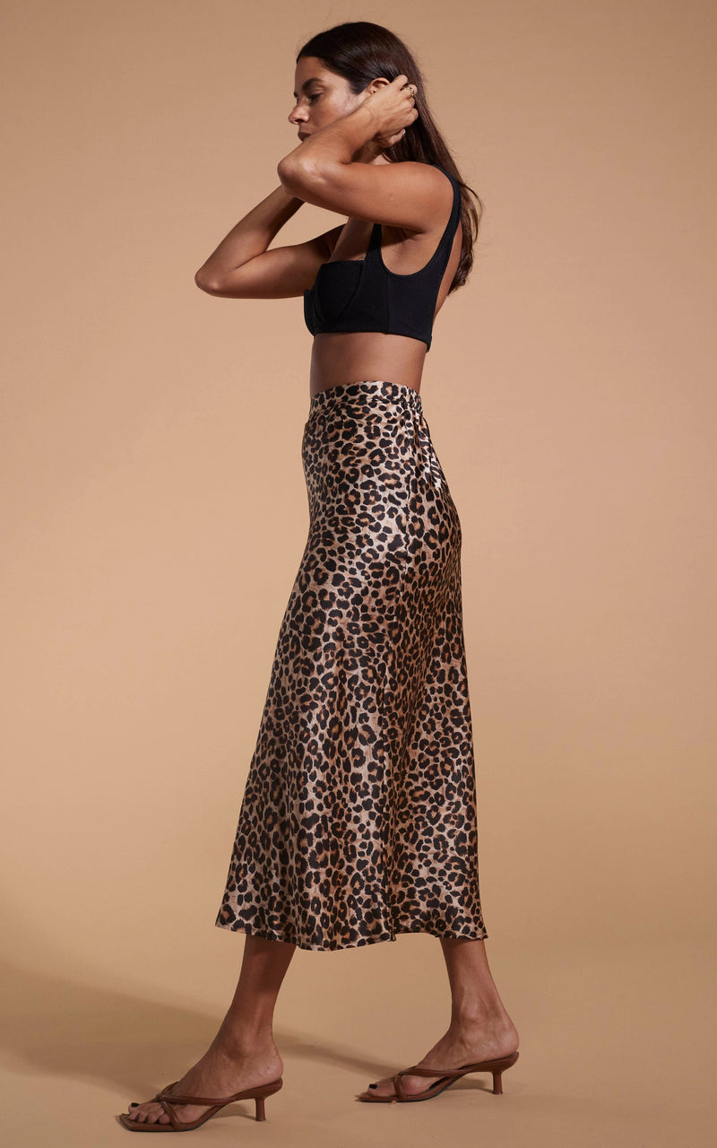 Dancing Leopard model wearing Renzo Skirt In Rich Leopard walking from right to left with hands on head