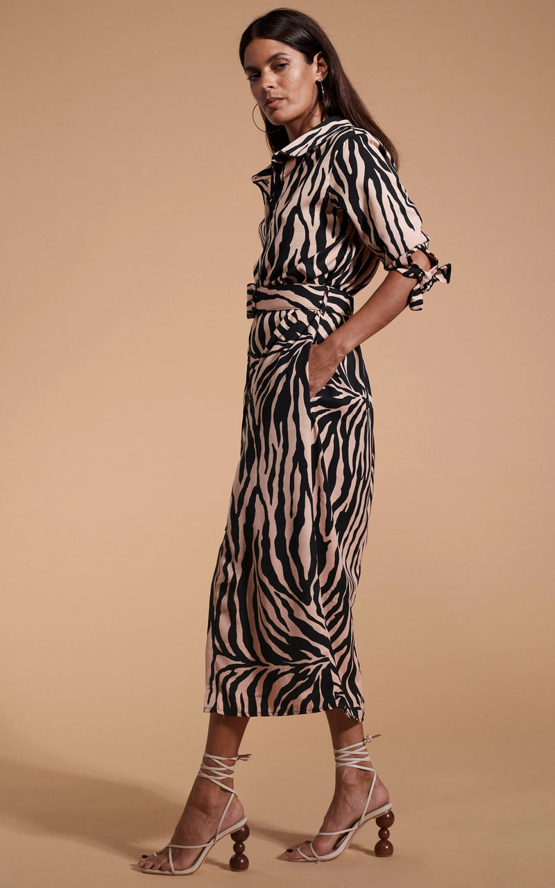 Dancing Leopard model wearing Alva Midi Shirt Dress In Blush Zebra stood side on with hands in pockets