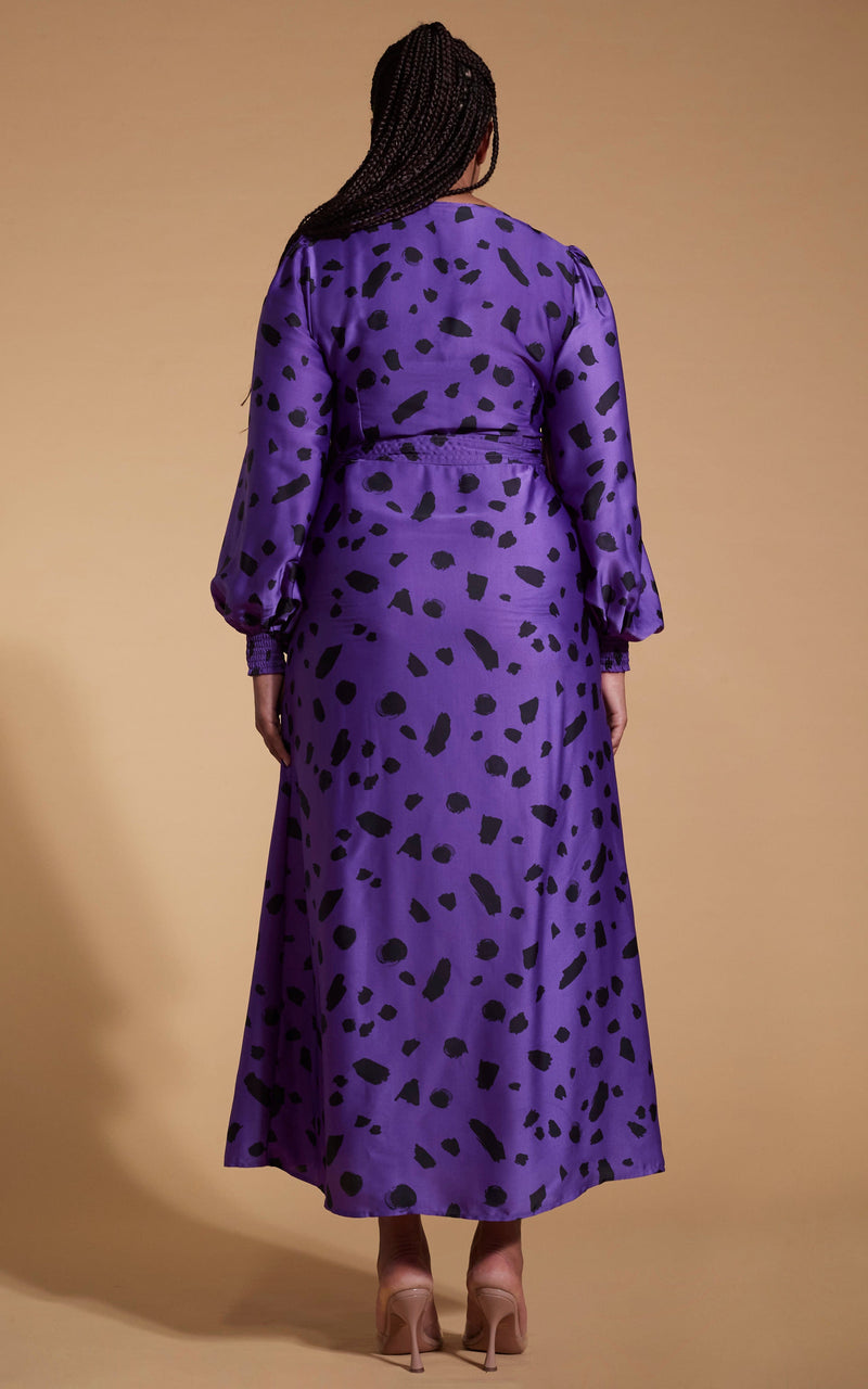 Model facing backwards wearing an abstract purple Dancing Leopard dress.