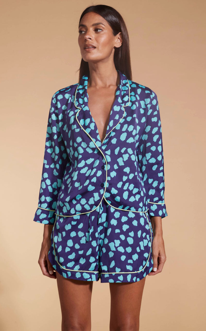 Model facing forward wearing the blue on navy cloud Dancing Leopard PJ set.