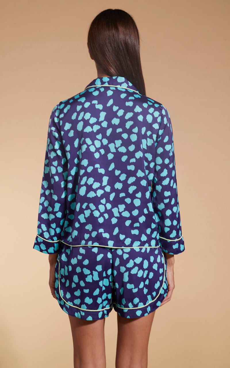 Model facing backwards wearing the blue on navy cloud Dancing Leopard PJ set.