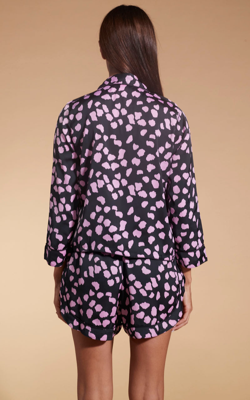 Model facing backwards wearing the pink on black cloud Dancing Leopard PJ set.