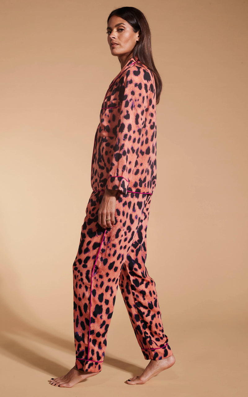 Model facing to the side wearing the Dancing Leopard Plorange Leopard set pyjamas.