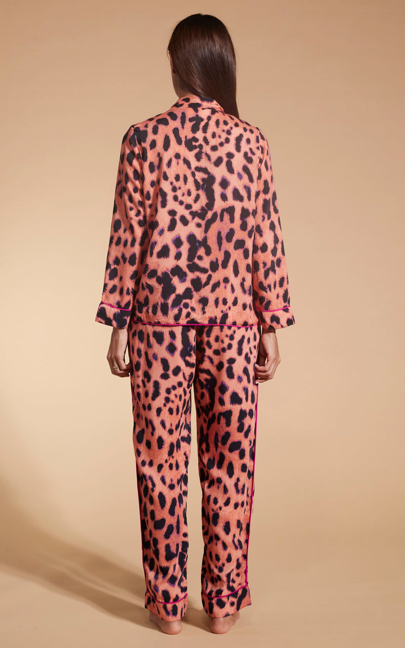 Model facing backwards wearing the Dancing Leopard Plorange Leopard set pyjamas.