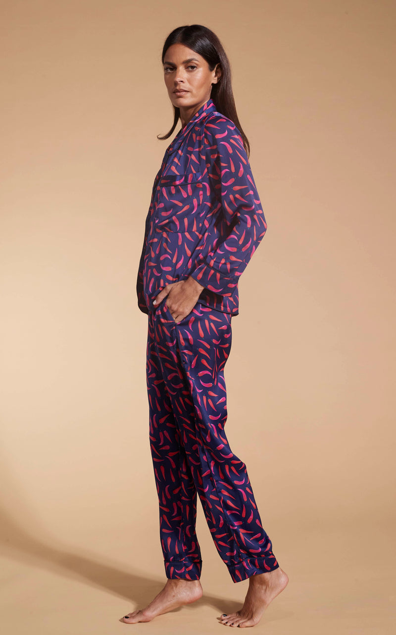 Model facing to the side wearing the Dancing Leopard Chilli Pepper set pyjamas.