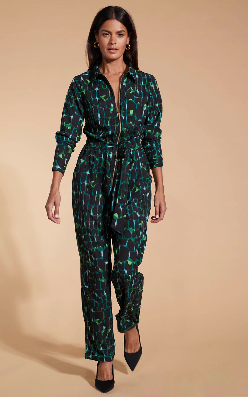 Model facing forward wearing the green alligator Dancing Leopard jumpsuit.