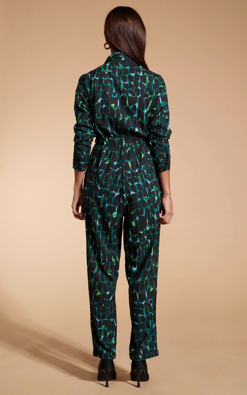 Model facing backwards wearing the green alligator Dancing Leopard jumpsuit.