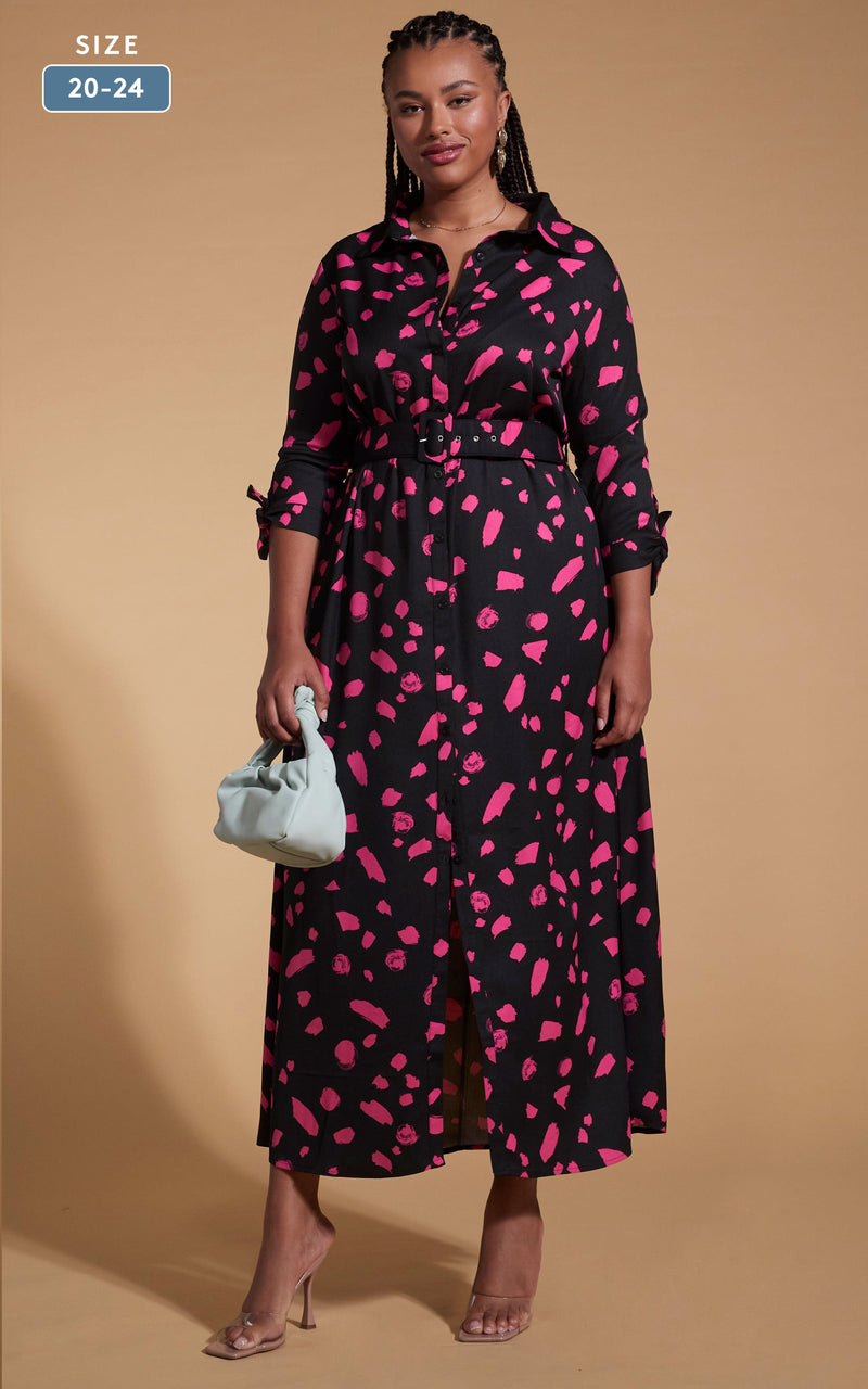 Model faces forward wearing a pink and black Dancing Leopard dress with a white bag.