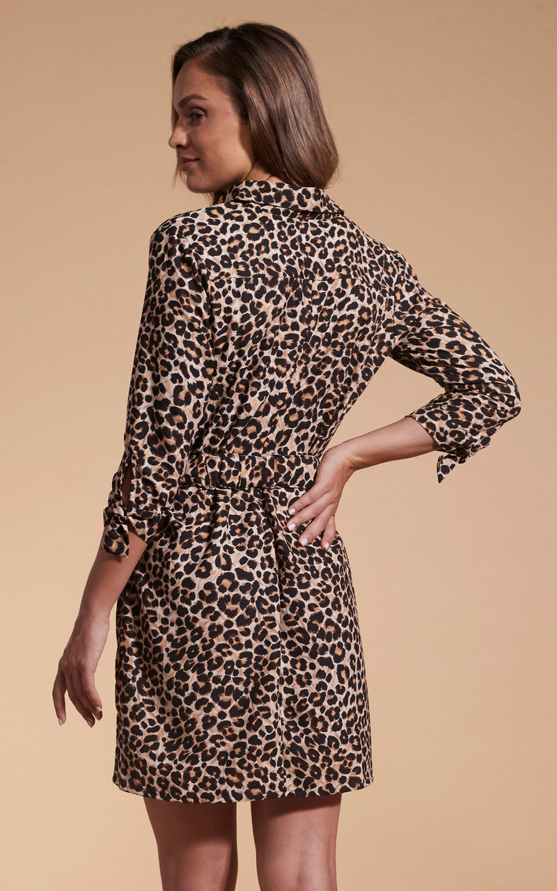 Model faces backwards wearing a short Dancing Leopard dress with leopard print.