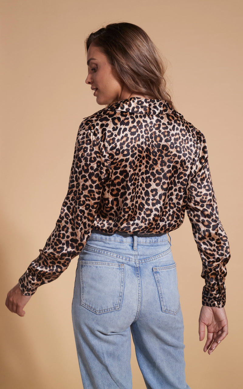 Model facing backwards wearing a leopard print Dancing Leopard top.