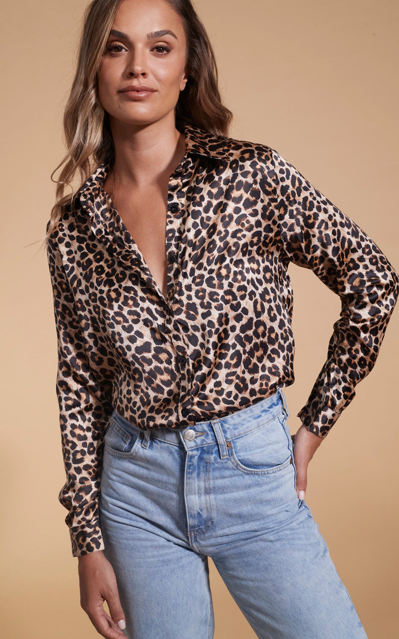 Model facing forward wearing a leopard print Dancing Leopard top.
