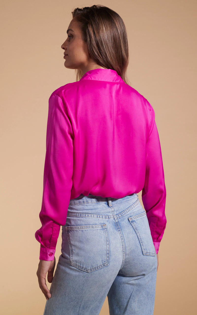 Model faces backwards wearing a magenta Dancing Leopard top.