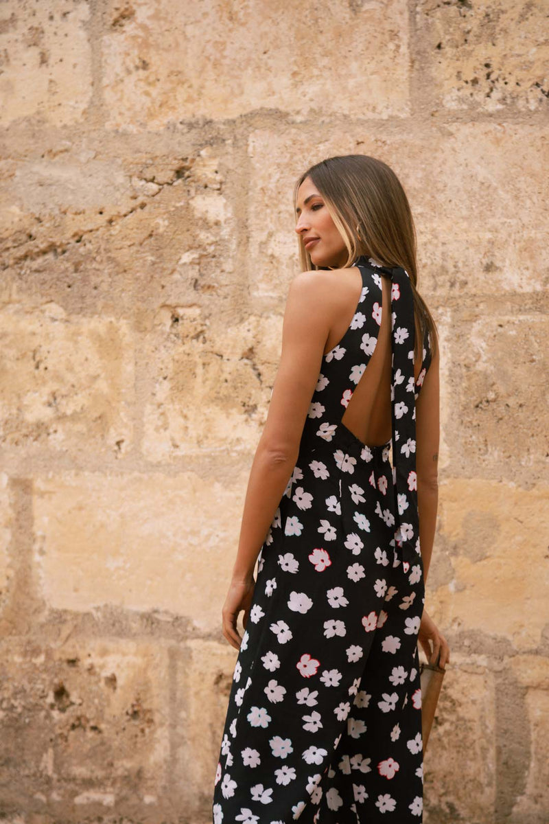 Dancing Leopard model with back turned wearing Cypress Jumpsuit in Mono Daisy