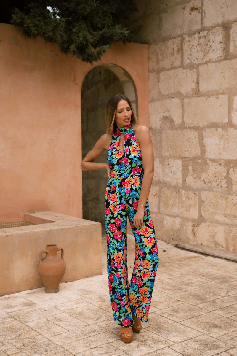 Dancing Leopard model stood with hand on hip wearing Cypress Jumpsuit in Vintage Floral
