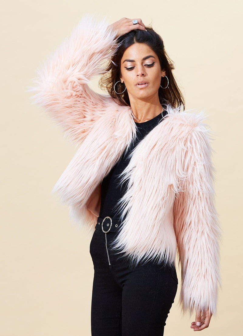 Model facing forward wearing a pink Dancing Leopard faux fur jacket.