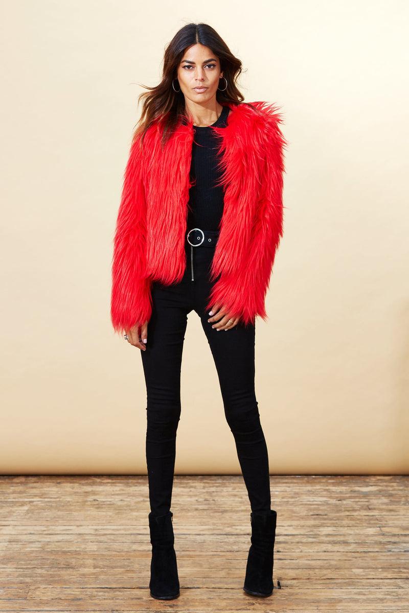 Model facing forward wearing a red Dancing Leopard faux fur jacket.
