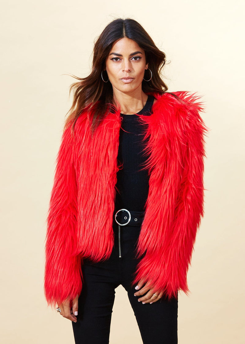 Model facing forward wearing a red Dancing Leopard faux fur jacket.