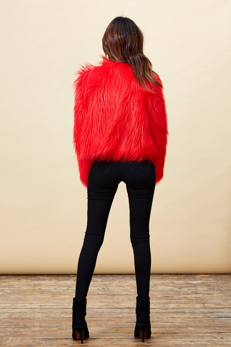 Model facing backwards wearing a red Dancing Leopard faux fur jacket.