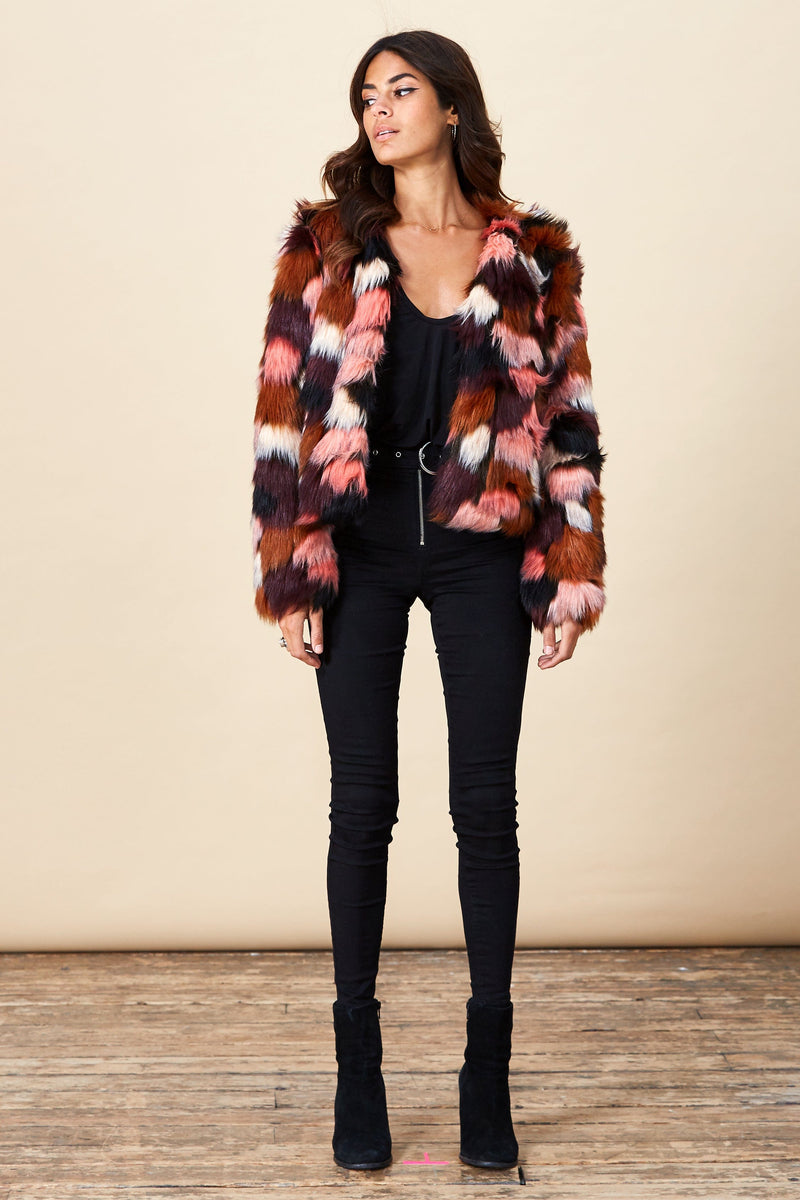 Model facing forward wearing a muticolour Dancing Leopard faux fur jacket.
