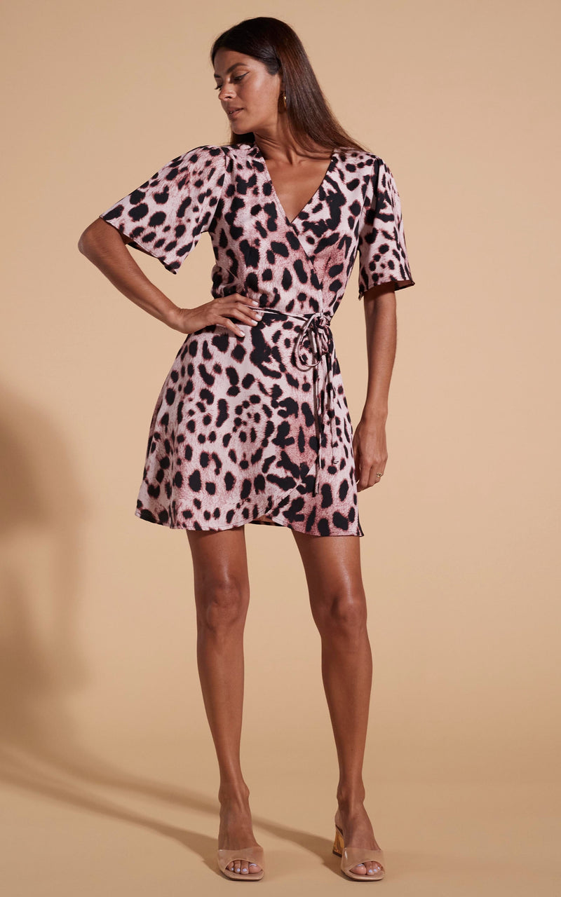 Dancing Leopard model wearing Rafferty Dress In Blush Leopard posed with hand on hip looking to the side