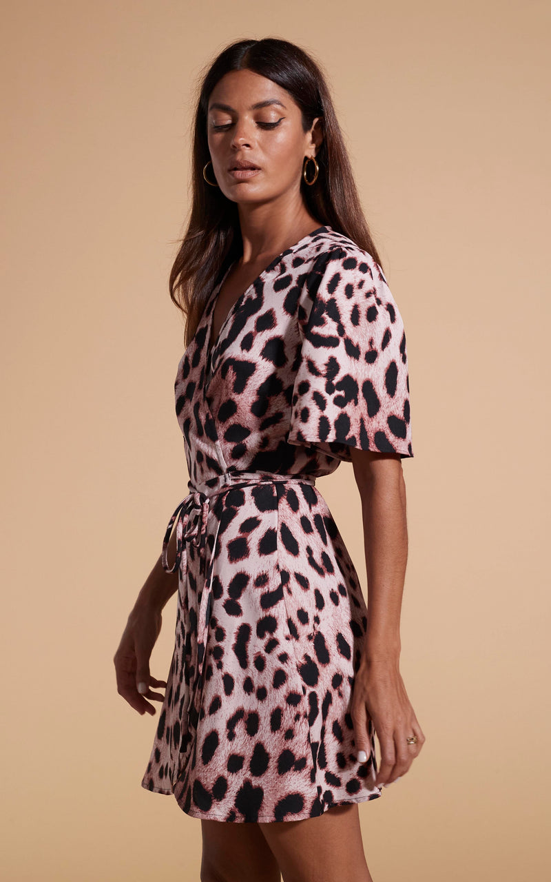 Dancing Leopard model wearing Rafferty Dress In Blush Leopard facing side on