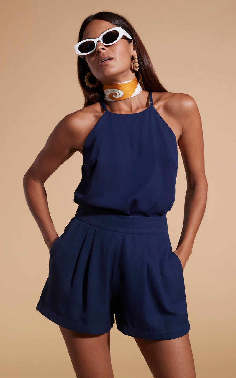 Dancing Leopard model wearing Nina Halter Cami Top In Navy with matching shorts and sunglasses posed with hands in pockets