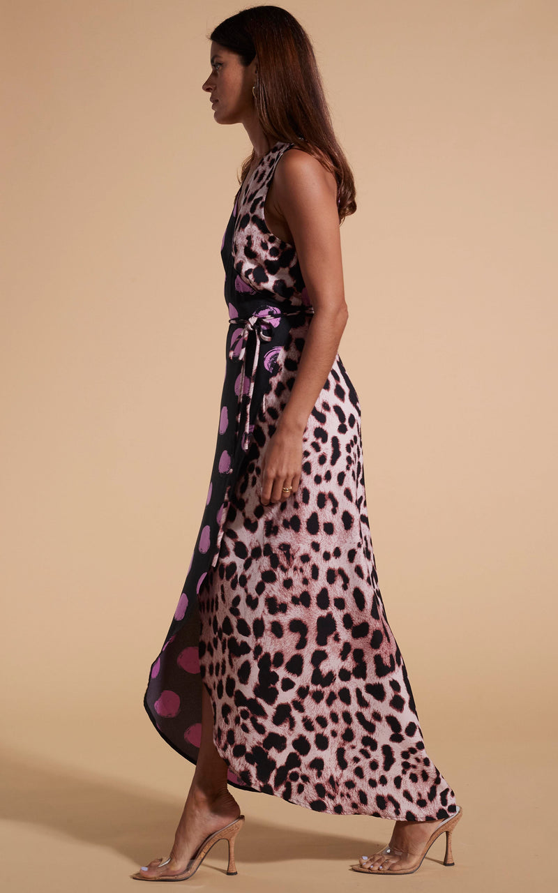 Model walks to the side wearing polka dot and leopard print wrap dress with heels