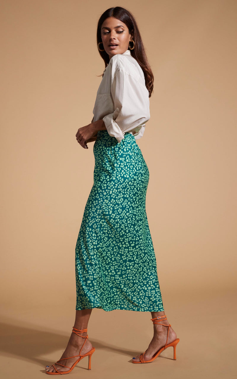 Dancing Leopard model wearing Renzo Skirt In Green On Green Leopard facing side on