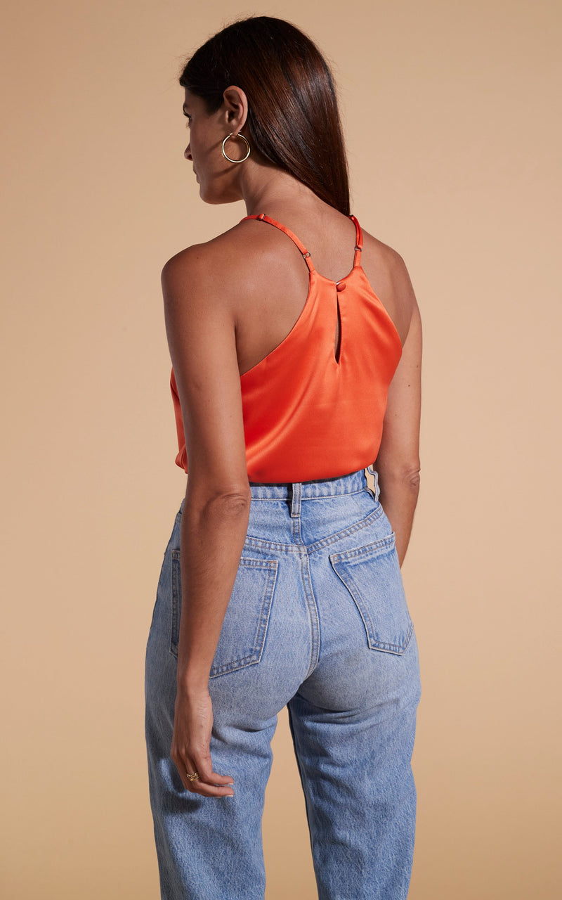 Dancing Leopard model wearing Nina Halter Cami Top In Orange facing away to show back details