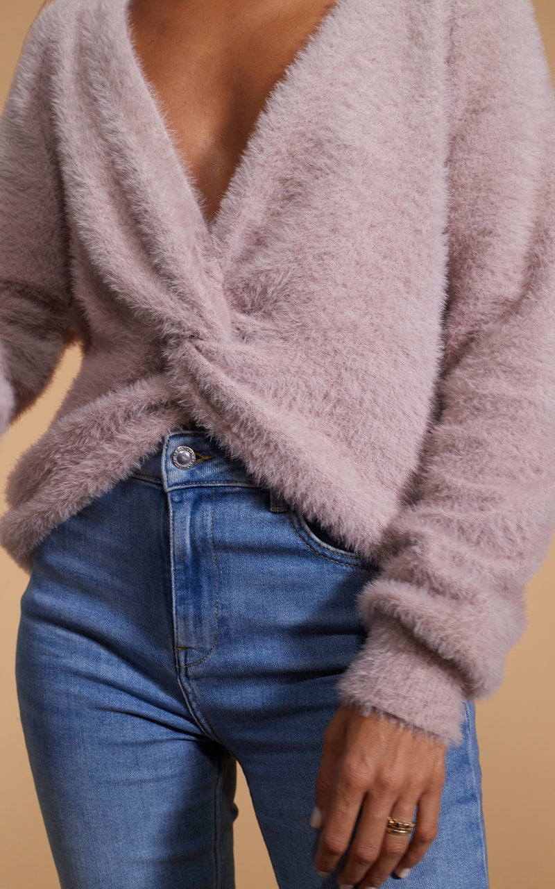 Female model faces forwards. She wears a Dancing Leopard mink jumper with a tie-knot front and denim jeans.