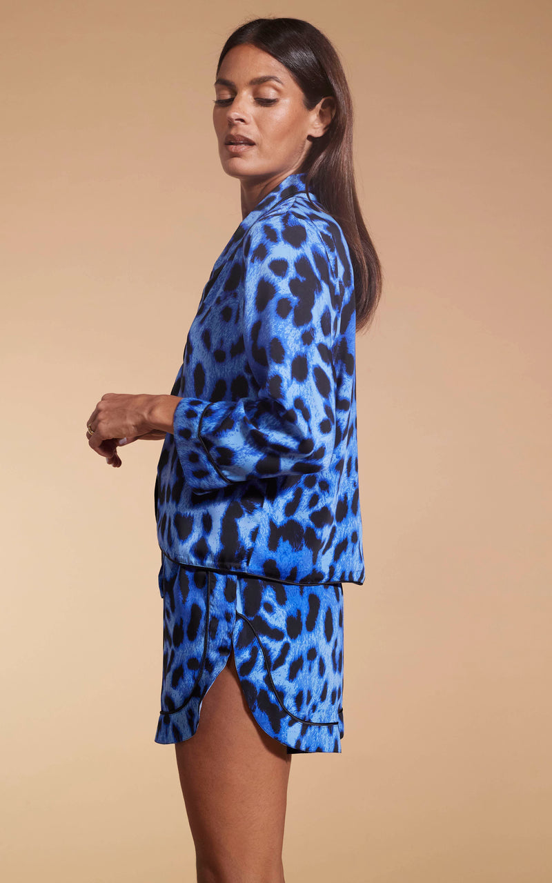 Model facing to the side  wearing the Oona Shortie PJ Set In Bright Blue Leopard.