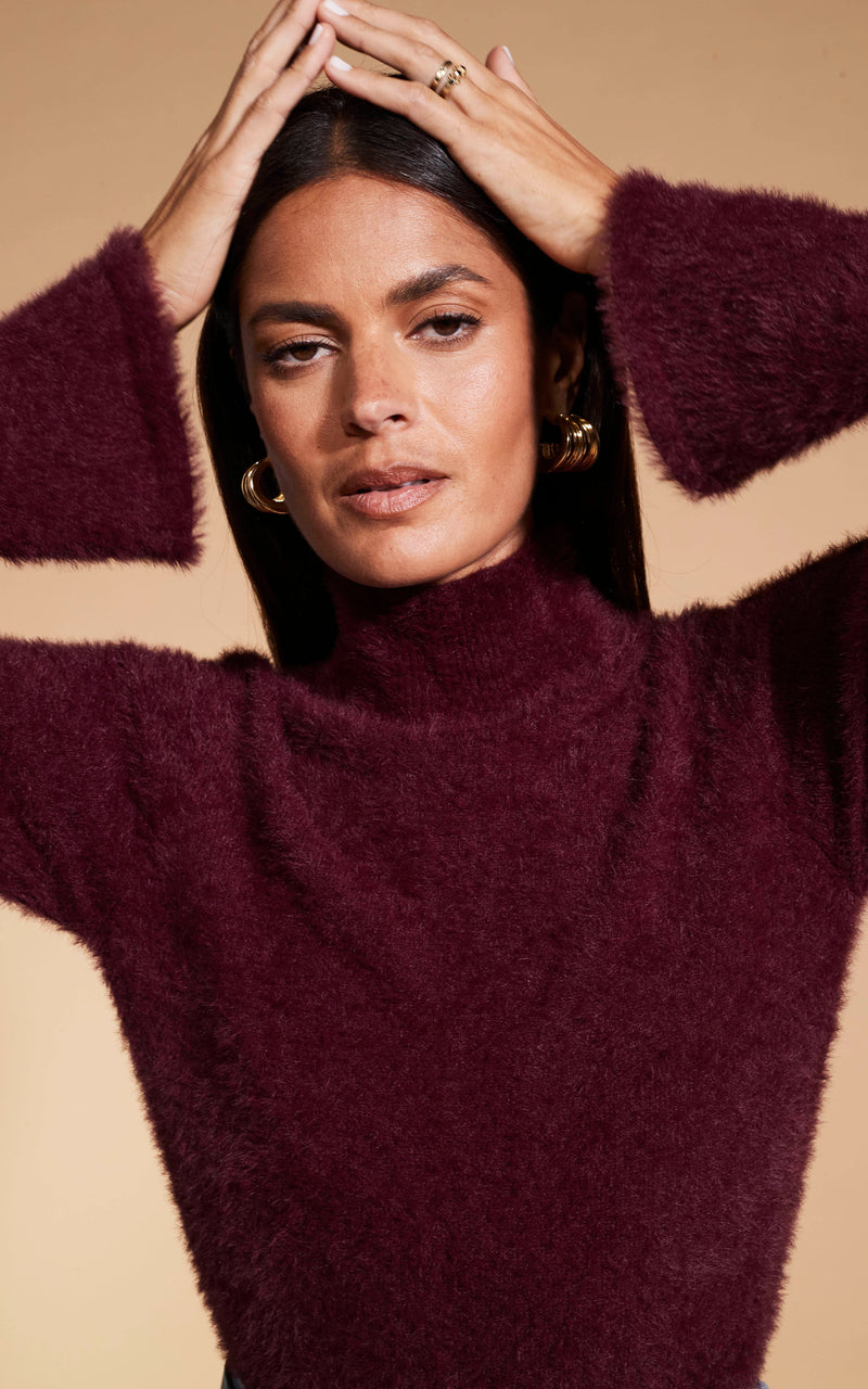 Model faces forward wearing Dancing Leopard burgunday knitted jumper