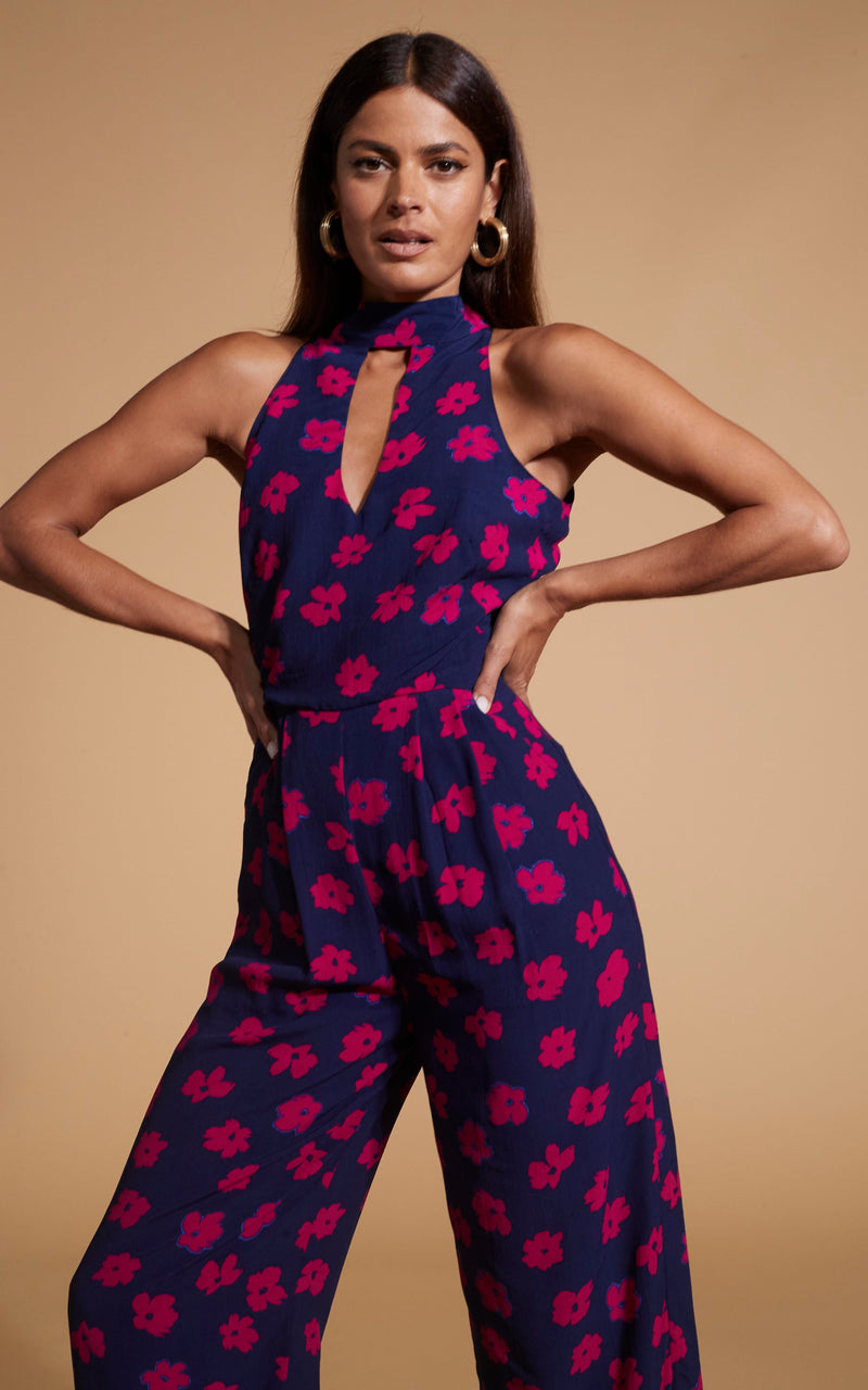 Dancing Leopard model wearing Cypress Jumpsuit In Pink Daisy posed with hands on hips