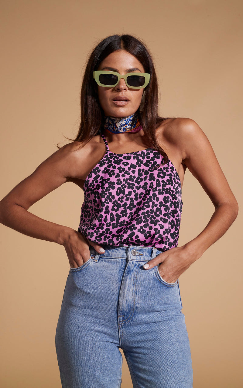 Dancing Leopard model wearing Nina Halter Cami Top In Black On Pink Leopard with sunglasses and hands in pockets