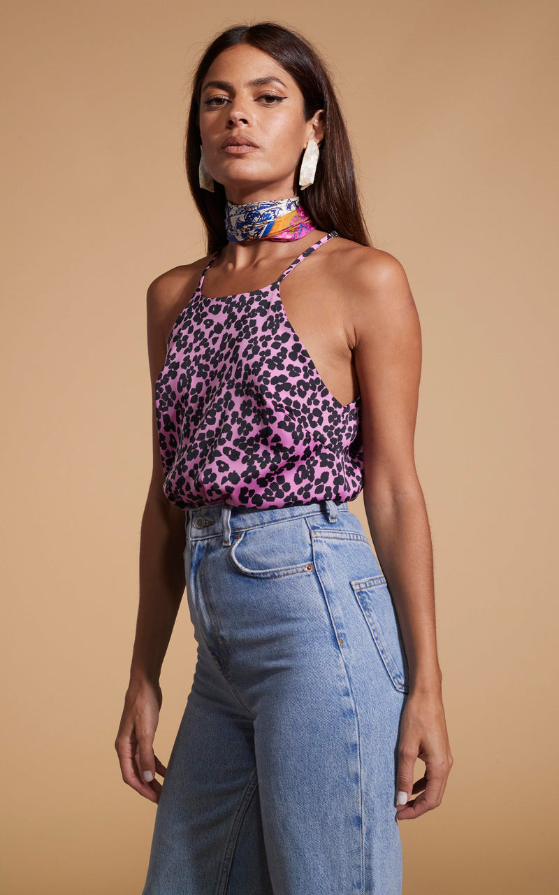 Dancing Leopard model wearing Nina Halter Cami Top In Black On Pink Leopard facing side on