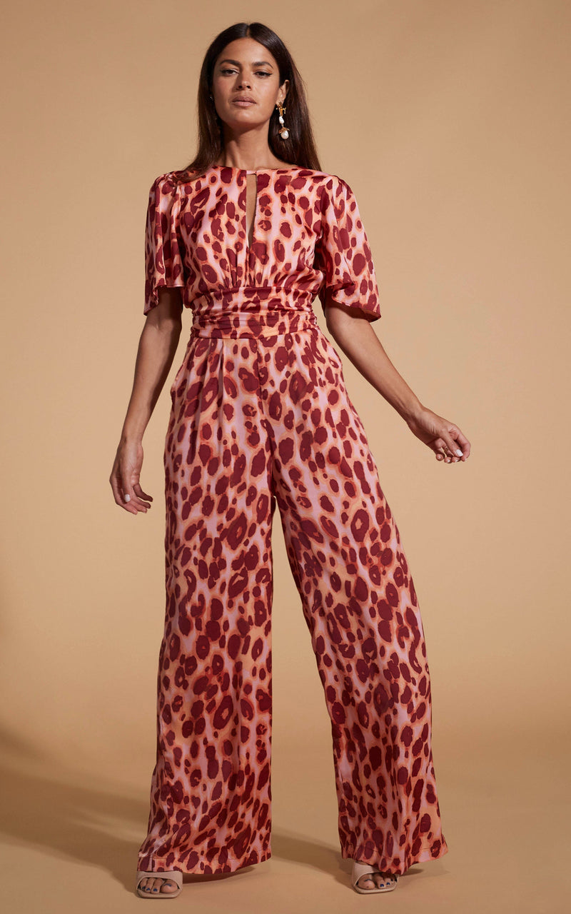 Dancing Leopard model wearing Savannah Jumpsuit In Orange Leopard