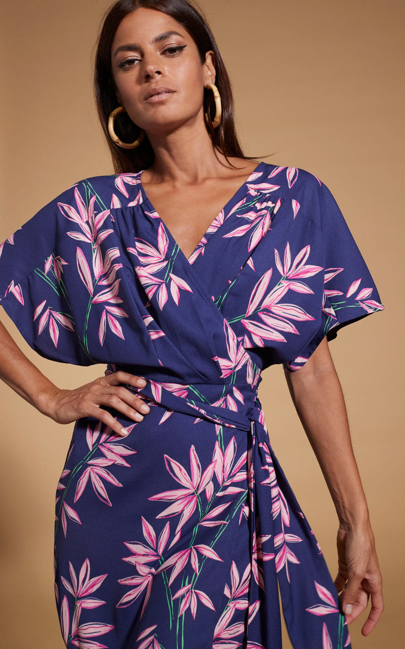 close up of Dancing Leopard model wearing Kansas Mini Wrap Dress in Bamboo Navy Base posed with hand on hip