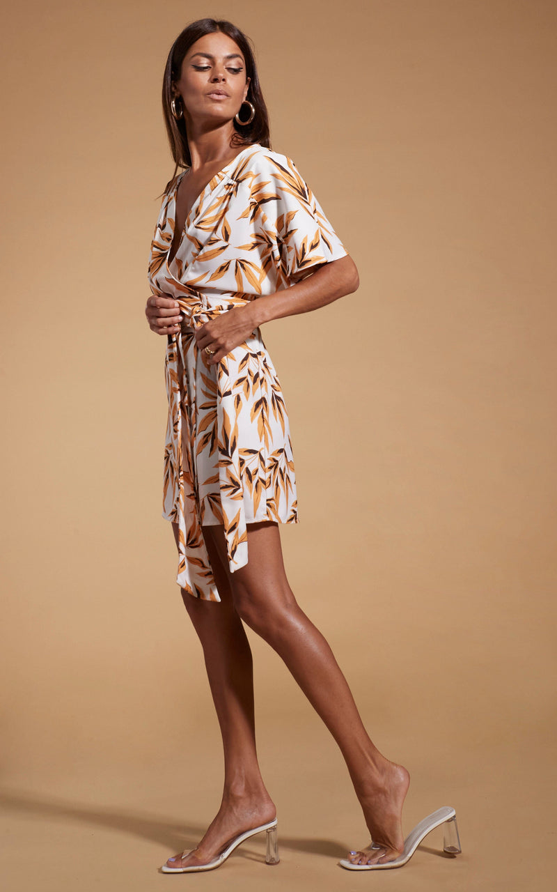 Dancing Leopard model wearing Kansas Mini Wrap Dress in Tropic Natural facing side on