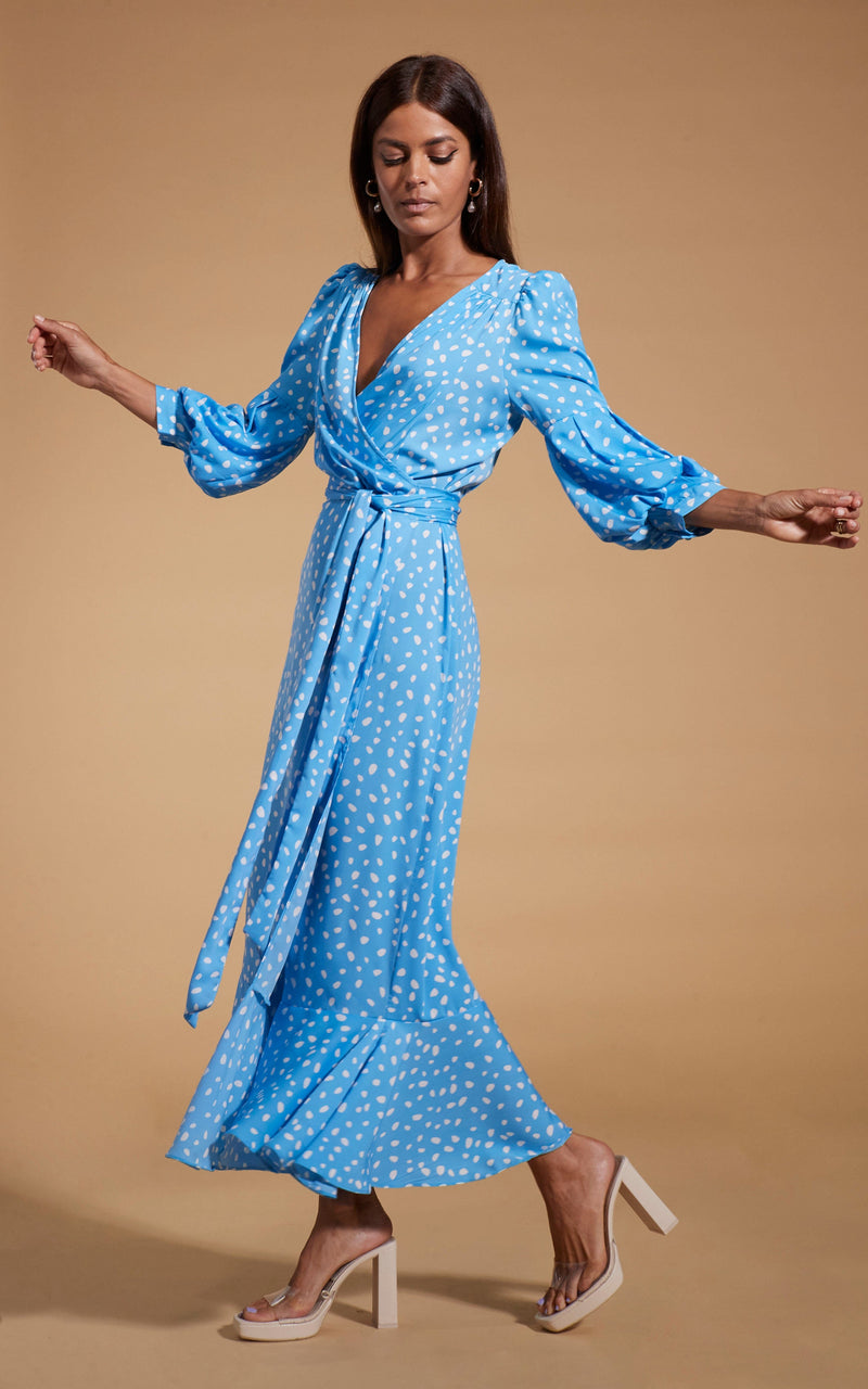 Dancing Leopard model wearing Havannah Maxi Wrap Dress in Abstract White on Blue posing looking down at feet