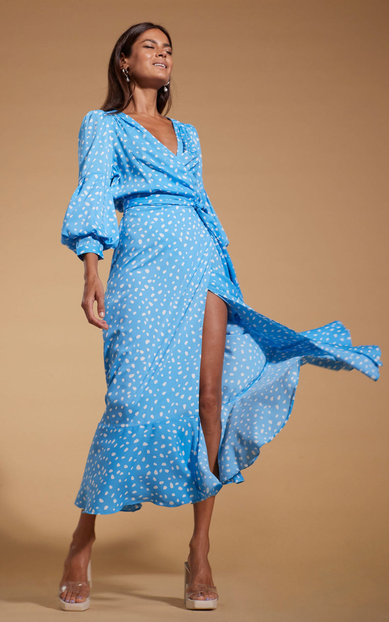 Dancing Leopard model wearing Havannah Maxi Wrap Dress in Abstract White on Blue with skirt flowing