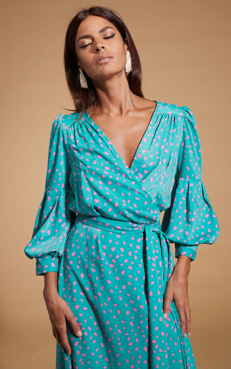 close up of Dancing Leopard model wearing Havannah Maxi Wrap Dress in Abstract Pink on Sea Green posing with eyes closed