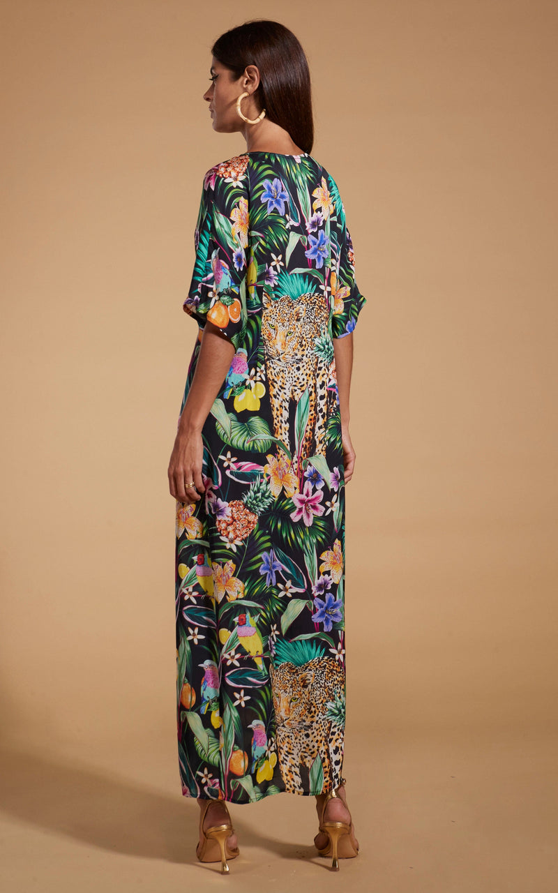 Dancing Leopard model wearing Makuna Kaftan In Paradise Jungle facing away to show back of dress