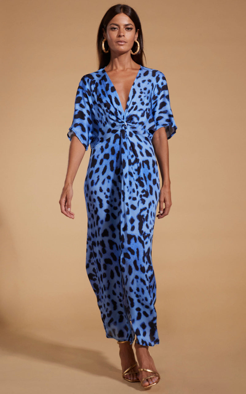 Dancing Leopard model wearing Makuna Kaftan In Bright Blue Leopard walking towards shot