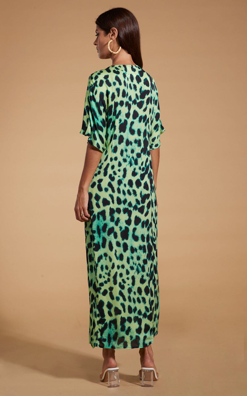 Dancing Leopard model wearing Makuna Kaftan In Lime Leopard facing away to show back of dress