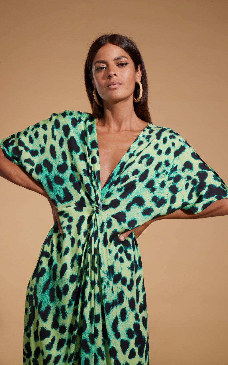 Dancing Leopard model wearing Makuna Kaftan In Lime Leopard posed with hands on hips